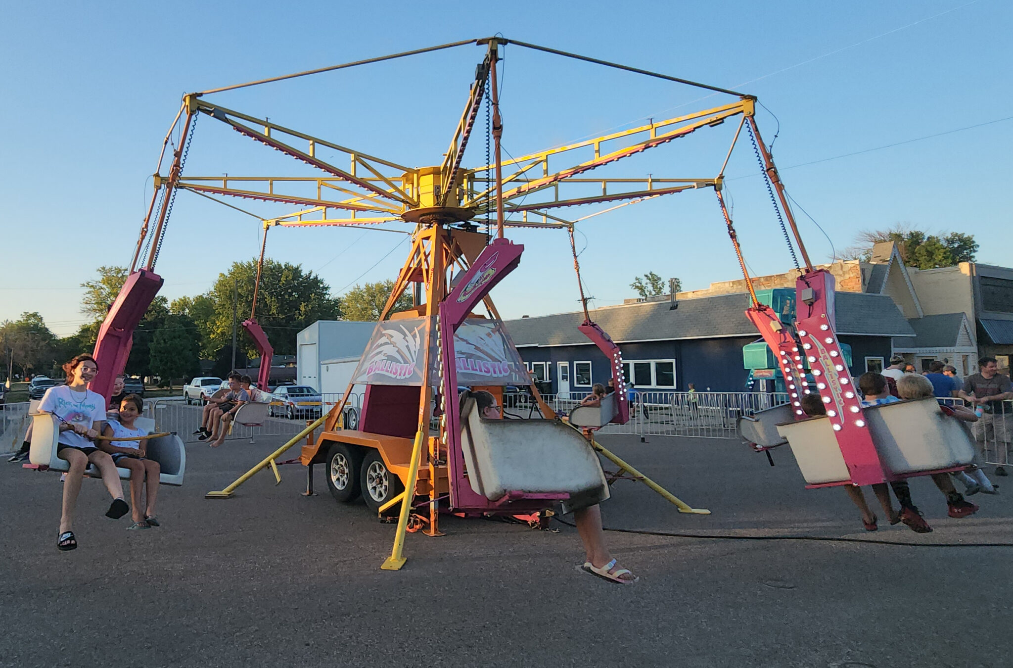 A picture of a small carousel ride set up a mobile platform